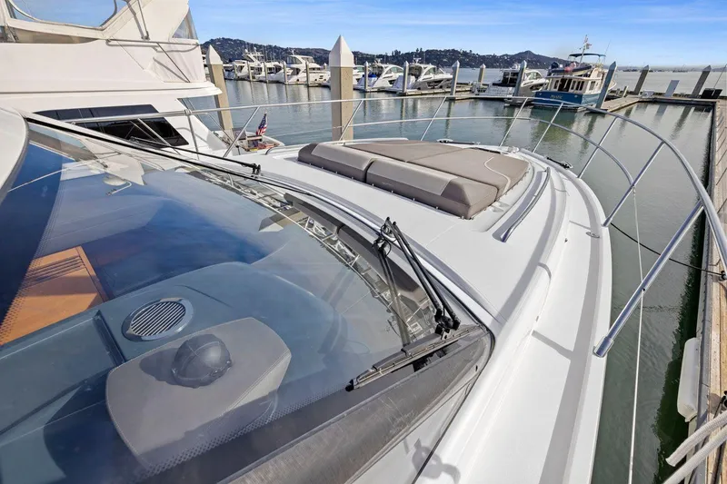 Slide: The Image of 2019 Princess V50 yacht docked at marina, showcasing sleek design and spacious deck. - 17