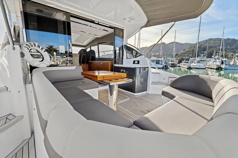 Slide: The Image of Luxurious 2019 Princess V50 yacht interior with elegant seating and marina view. - 18