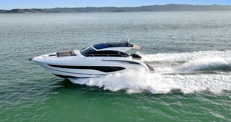 Slide: The Image of 2019 Princess V50 yacht cruising swiftly on open water. - 2
