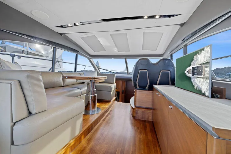 Slide: The Image of Luxurious interior of 2019 Princess V50 yacht with modern seating and panoramic windows. - 24