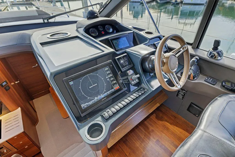 Slide: The Image of 2019 Princess V50 yacht helm with navigation screens and steering wheel. - 27