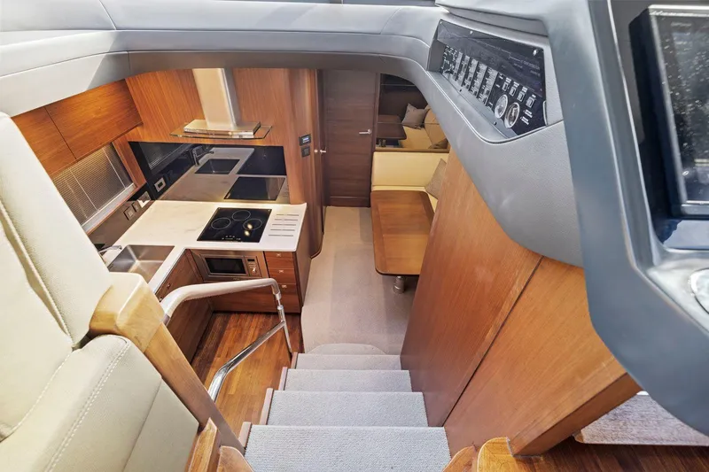 Slide: The Image of Interior of 2019 Princess V50 yacht, featuring modern kitchen and seating area. - 30