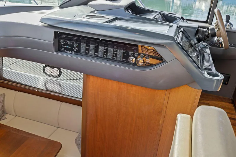 Slide: The Image of Interior helm of 2019 Princess V50 yacht with modern controls and wood accents. - 33