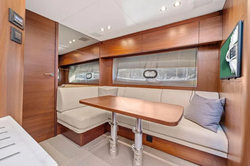 Slide: The Image of Luxurious interior of 2019 Princess V50 yacht with elegant wood finish and cozy seating area. - 34