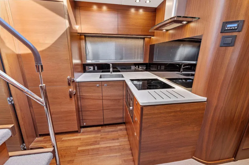 Slide: The Image of Luxurious 2019 Princess V50 yacht kitchen with modern wood cabinetry and sleek appliances. - 35