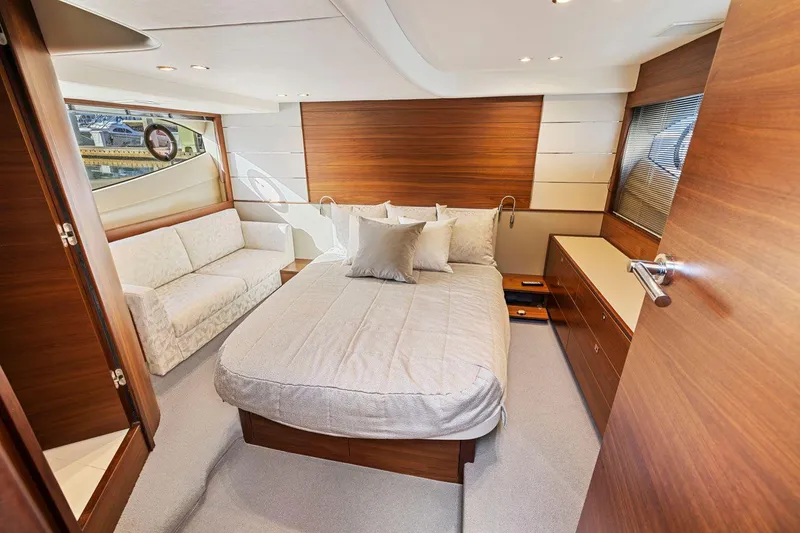 Slide: The Image of Luxurious 2019 Princess V50 yacht bedroom with modern wood accents and elegant furnishings. - 38