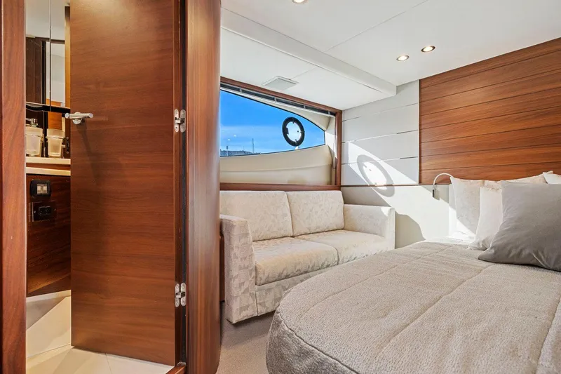 Slide: The Image of Luxurious 2019 Princess V50 yacht interior with cozy bedroom and elegant wood finishes. - 39