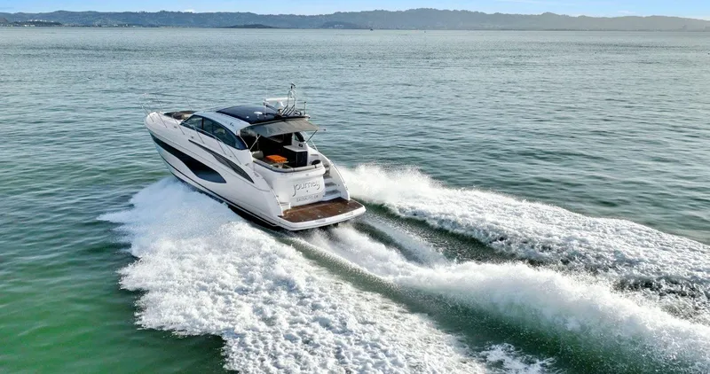 Slide: The Image of 2019 Princess V50 yacht cruising on open water, leaving a trail of white waves. - 4