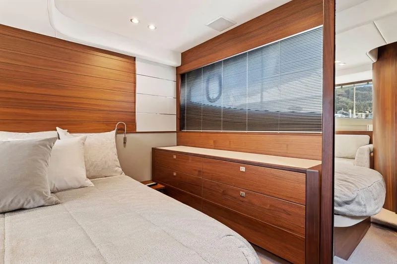 Slide: The Image of Luxurious 2019 Princess V50 yacht bedroom with modern wood paneling and elegant decor. - 40