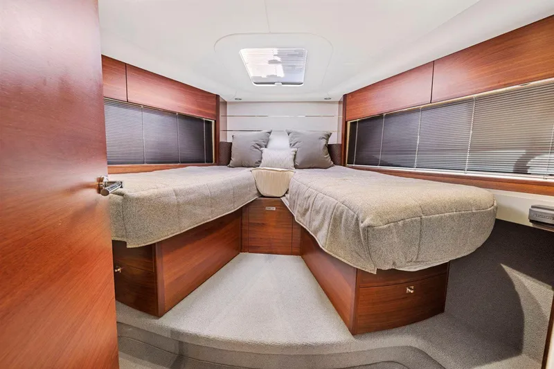 Slide: The Image of Luxurious 2019 Princess V50 yacht cabin with twin beds and modern wood finish. - 43