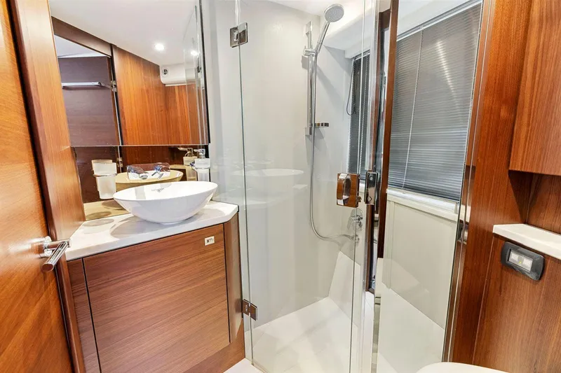 Slide: The Image of Luxurious bathroom in 2019 Princess V50 yacht with modern fixtures and wood accents. - 45