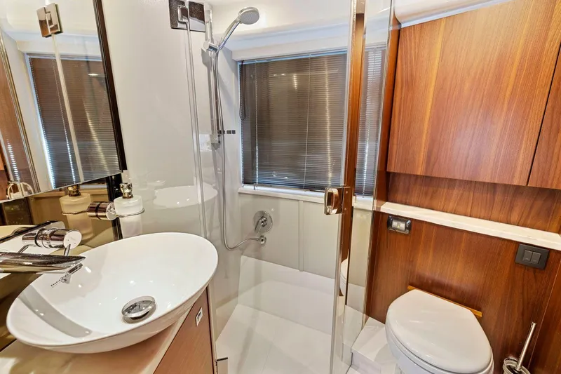 Slide: The Image of Luxurious bathroom in 2019 Princess V50 yacht with modern fixtures and wooden accents. - 46