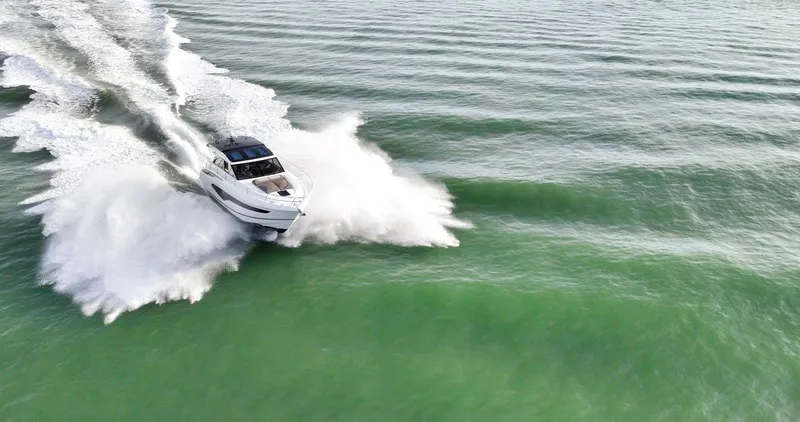 Slide: The Image of 2019 Princess V50 yacht cruising on open water, creating a dynamic wake. - 5
