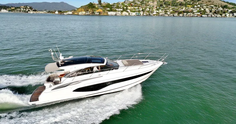 Slide: The Image of 2019 Princess V50 yacht cruising on scenic coastal waters. - 8