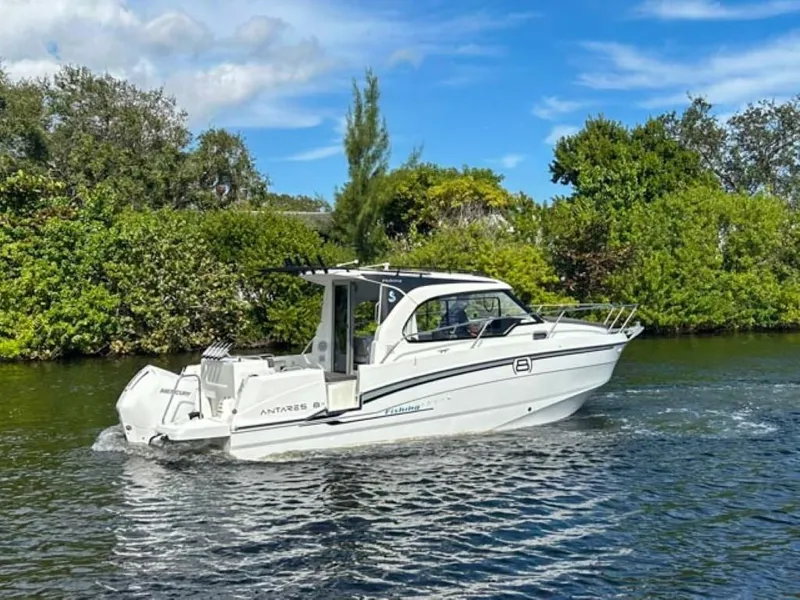 Slide: The Image of 2023 Beneteau Antares 8 cruising on a scenic river with lush greenery. - 1