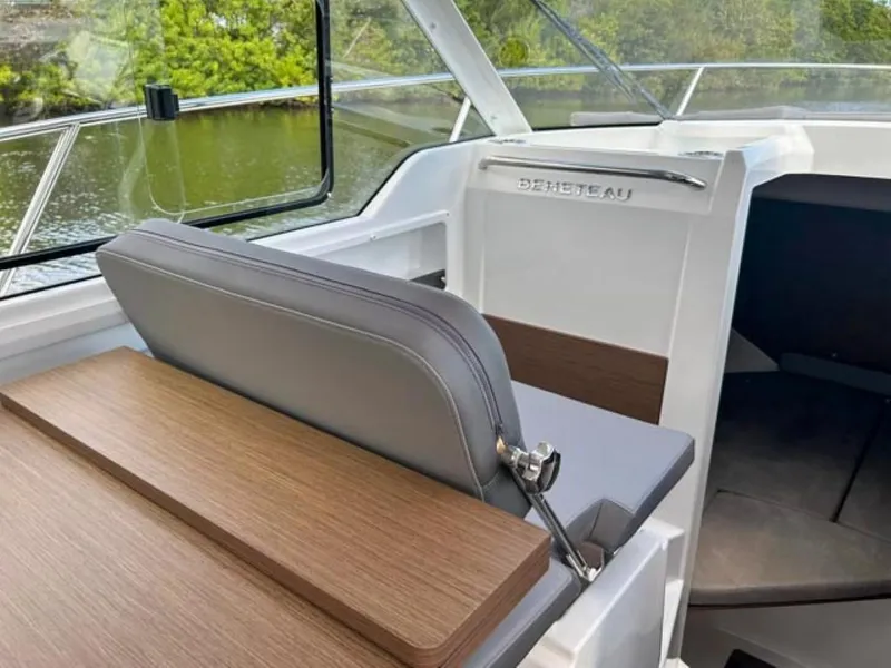 Slide: The Image of 2023 Beneteau Antares 8 interior with sleek seating and wooden accents. - 10