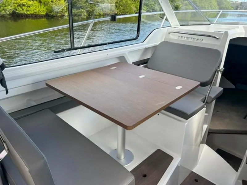 Slide: The Image of Interior of 2023 Beneteau Antares 8 with dining table and seating. - 11