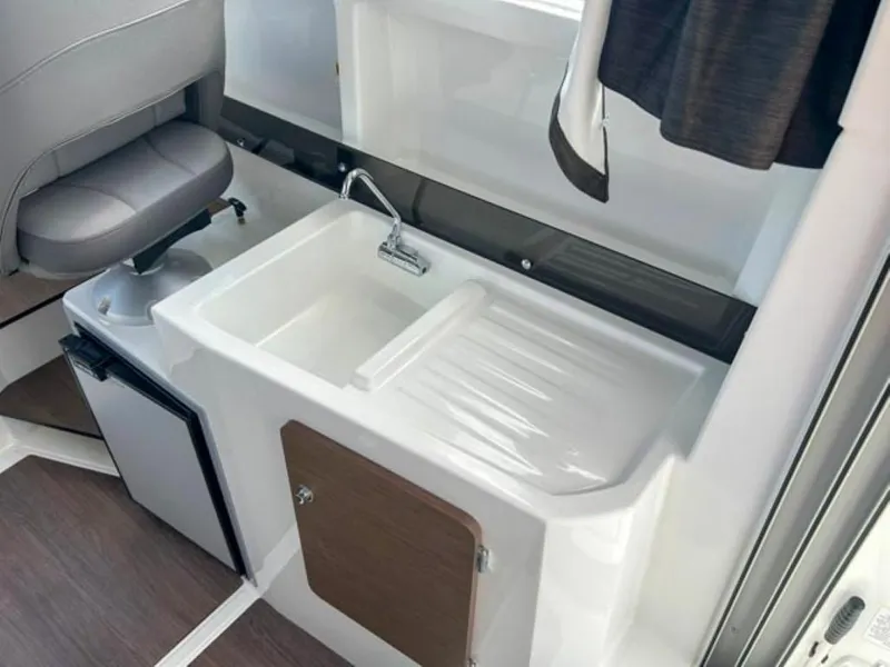 Slide: The Image of Interior of 2023 Beneteau Antares 8, featuring a compact sink and seating area. - 13