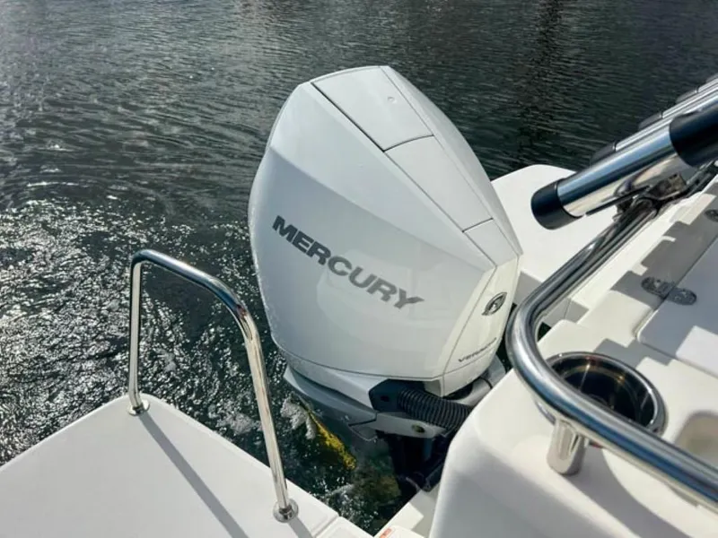 Slide: The Image of Mercury outboard motor on 2023 Beneteau Antares 8, docked on calm water. - 15