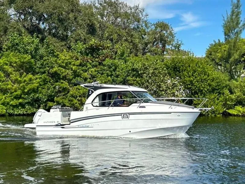 Slide: The Image of 2023 Beneteau Antares 8 cruising on a scenic river with lush greenery. - 3