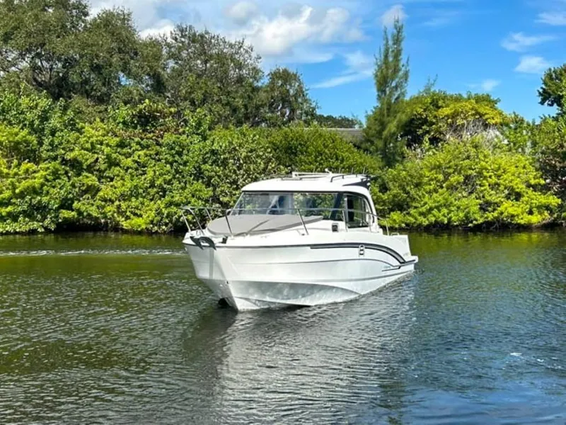 Slide: The Image of 2023 Beneteau Antares 8 cruising on a serene river, surrounded by lush greenery. - 4