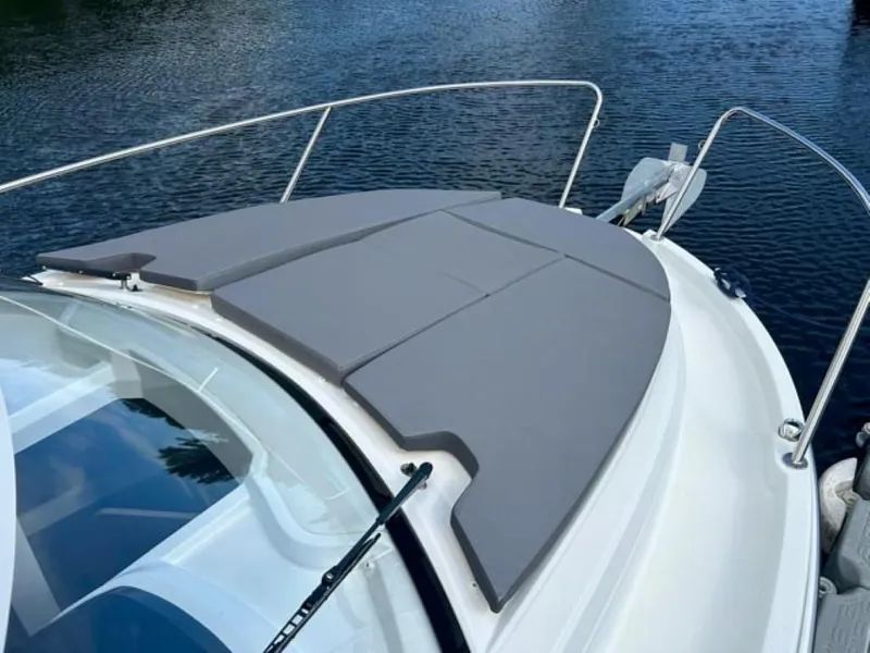 Slide: The Image of 2023 Beneteau Antares 8 boat with cushioned deck, on calm water. - 5