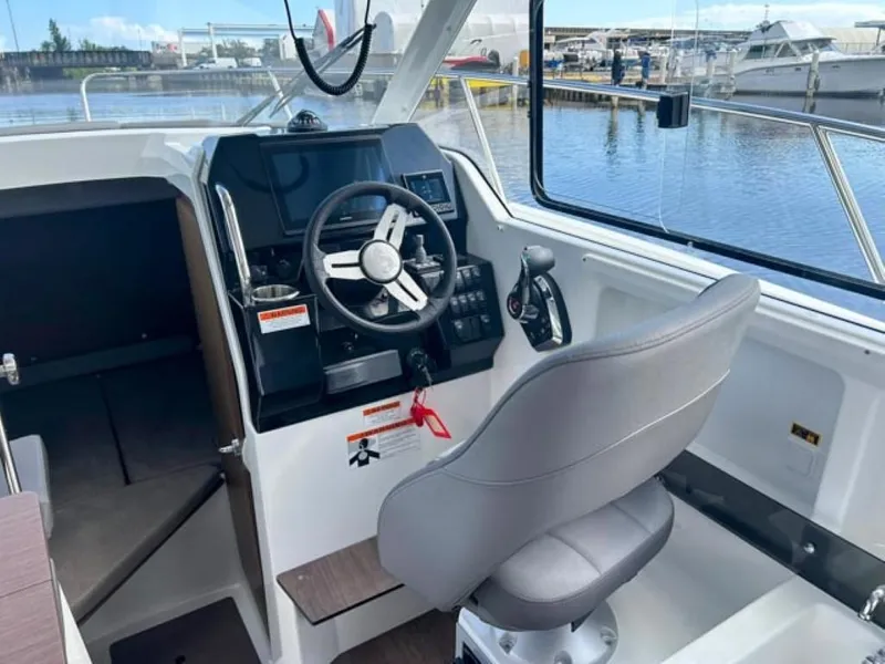 Slide: The Image of Interior view of 2023 Beneteau Antares 8 boat cockpit with steering wheel and controls. - 6
