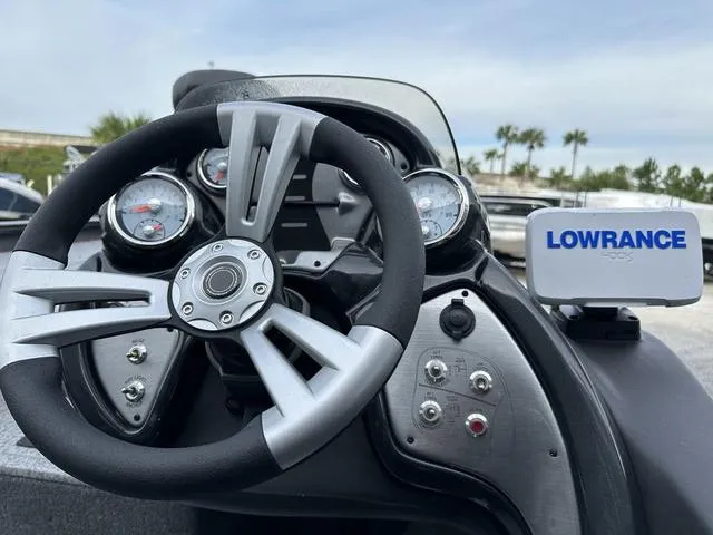 Slide: The Image of 2024 Tracker PROTEAM 195 TXW boat dashboard with steering wheel and Lowrance navigation system. - 8