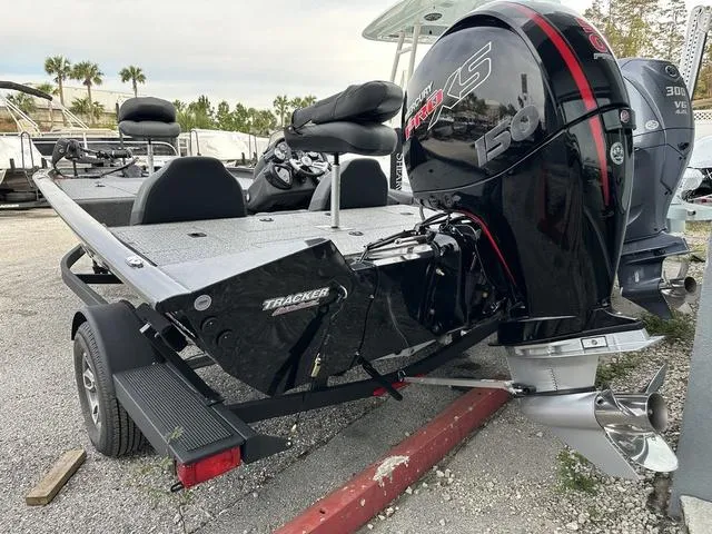 Slide: The Image of 2024 Tracker PROTEAM 195 TXW boat with powerful outboard motor, parked on a trailer. - 9
