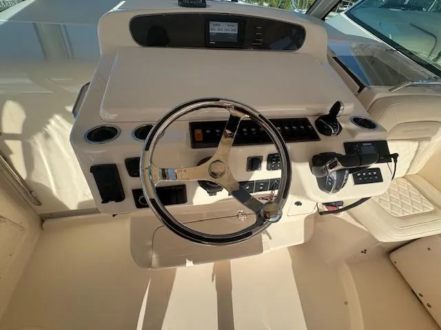 Slide: The Image of 2021 Grady-White Express 370 helm with steering wheel and control panel. - 12