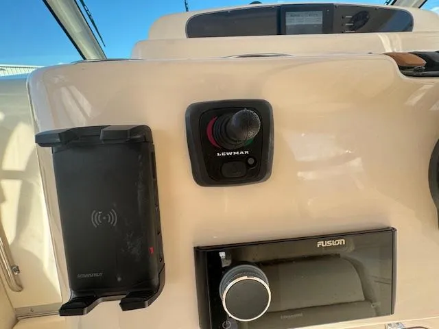 Slide: The Image of Grady-White Express 370 helm controls, featuring Lewmar joystick and Fusion audio system, 2021 model. - 13