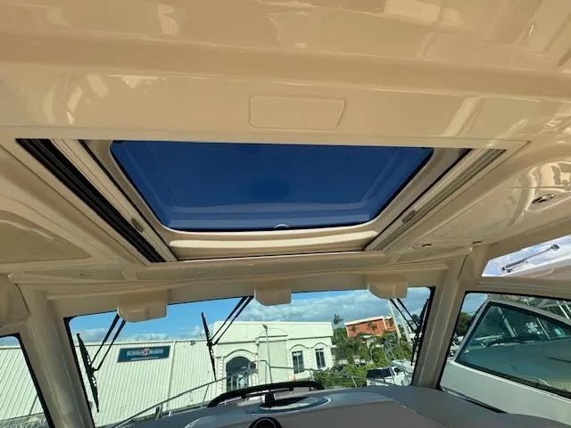 Slide: The Image of Grady-White Express 370 2021 boat interior with sunroof and clear sky view. - 14