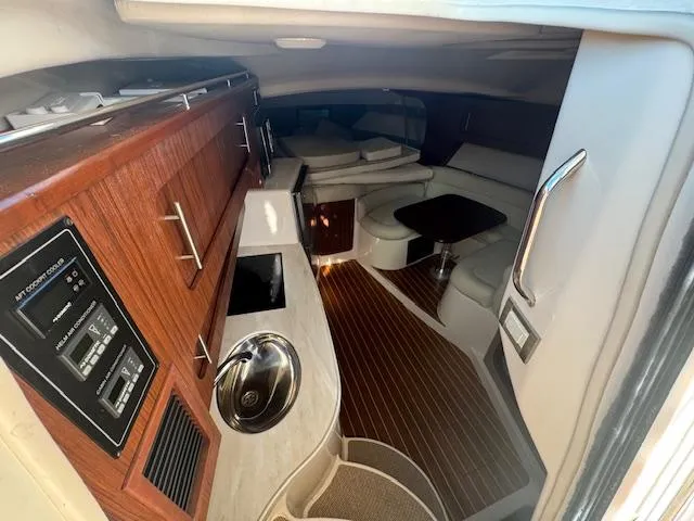 Slide: The Image of Interior of 2021 Grady-White Express 370 boat, featuring wood cabinetry and seating area. - 16