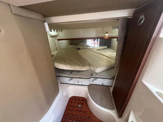 Slide: The Image of 2021 Grady-White Express 370 cabin interior with cozy sleeping area and wooden accents. - 17