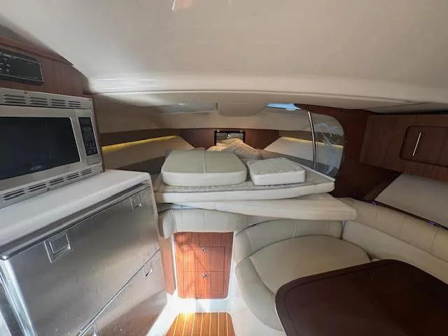 Slide: The Image of 2021 Grady-White Express 370 cabin interior with kitchenette and seating area. - 22