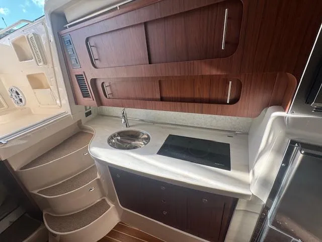 Slide: The Image of 2021 Grady-White Express 370 boat interior with kitchenette and wooden cabinetry. - 24