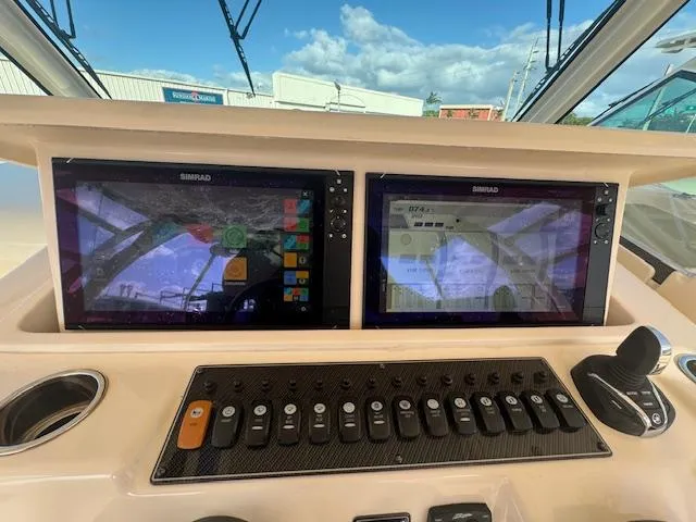Slide: The Image of 2021 Grady-White Express 370 helm with dual Simrad displays and control panel. - 28