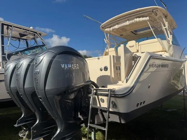 Slide: The Image of 2021 Grady-White Express 370 boat with Yamaha outboard engines, docked under clear skies. - 3