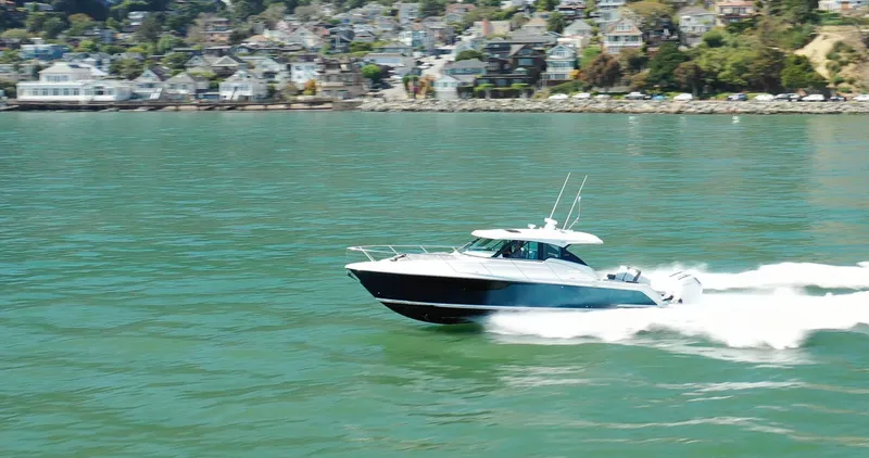 Slide: The Image of 2022 Tiara Yachts 43 LE cruising on a scenic waterway. - 0