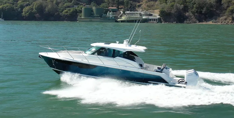 Slide: The Image of 2022 Tiara Yachts 43 LE cruising on a scenic lake. - 1