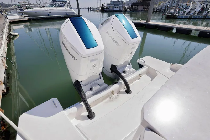 Slide: The Image of 2022 Tiara Yachts 43 LE with twin Mercury outboard engines docked in marina. - 10