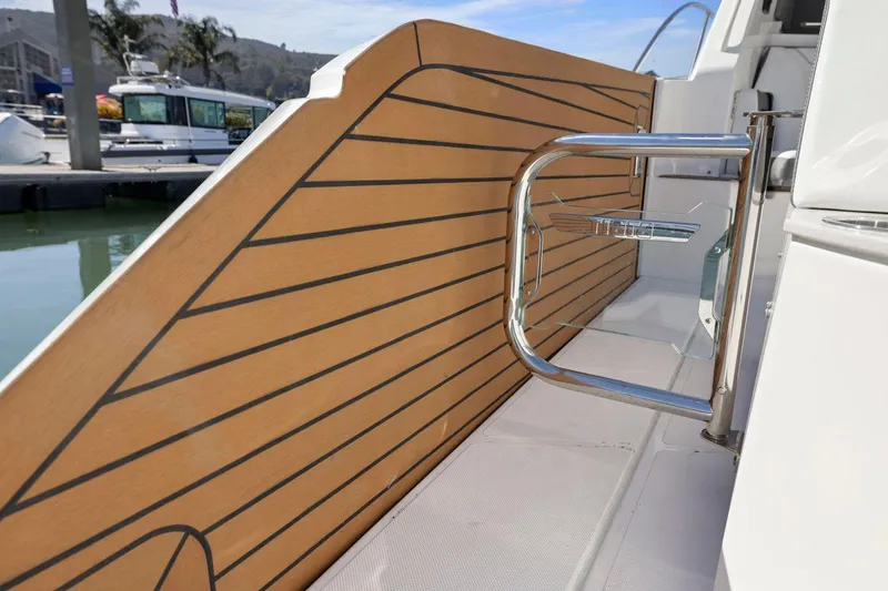 Slide: The Image of Tiara Yachts 2022 43 LE, sleek deck design with modern railing, docked at marina. - 15