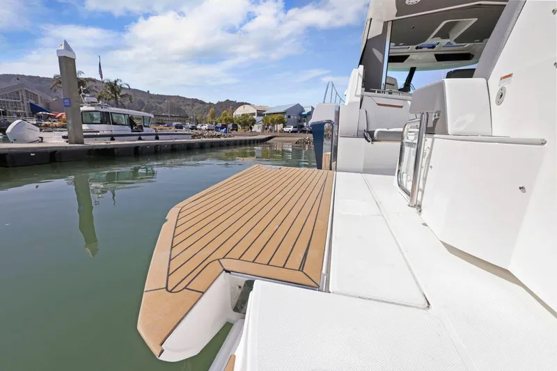 Slide: The Image of 2022 Tiara Yachts 43 LE docked, showcasing sleek design and spacious deck. - 16