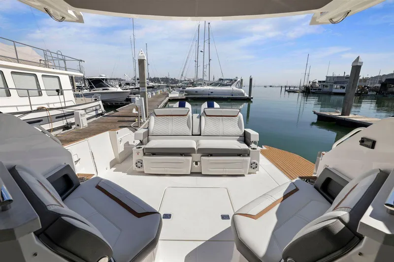 Slide: The Image of 2022 Tiara Yachts 43 LE interior with luxurious seating at marina. - 18