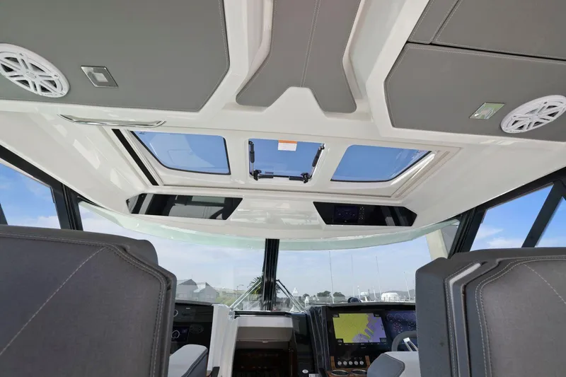 Slide: The Image of Interior view of 2022 Tiara Yachts 43 LE with skylight and modern dashboard. - 23