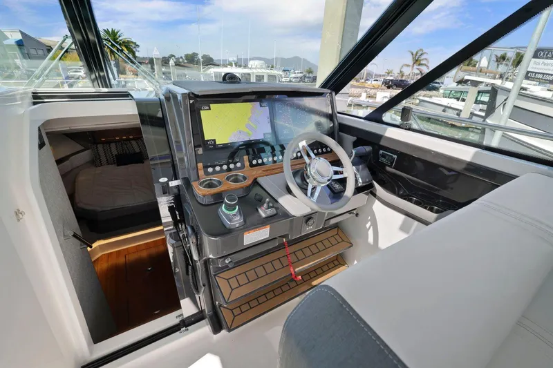 Slide: The Image of 2022 Tiara Yachts 43 LE helm with modern navigation system and luxurious interior. - 25