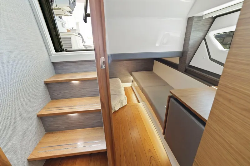 Slide: The Image of Interior of 2022 Tiara Yachts 43 LE, featuring wooden stairs and modern cabin design. - 31