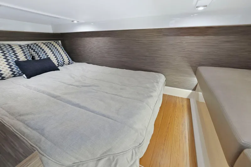 Slide: The Image of 2022 Tiara Yachts 43 LE cabin interior with bed and modern decor. - 32