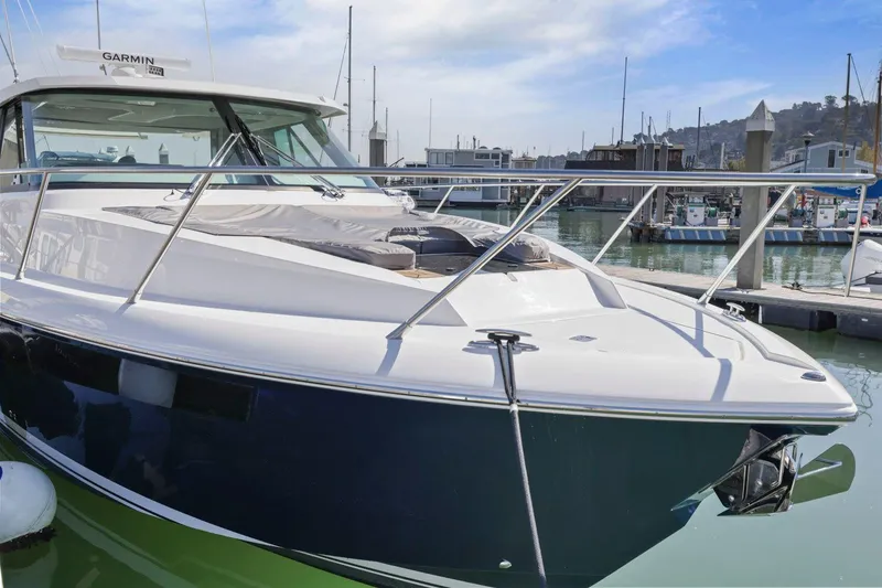 Slide: The Image of 2022 Tiara Yachts 43 LE docked in marina, sleek design, luxury boat. - 9