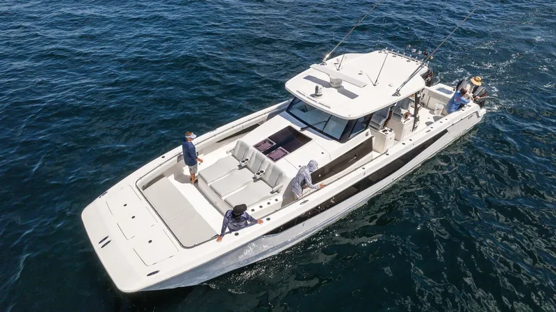 Slide: The Image of 2024 Aquila 47 Molokai yacht cruising on open water with passengers. - 2